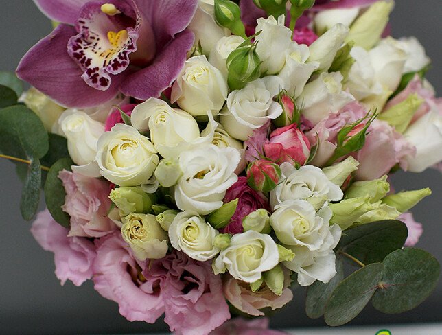 Bridal bouquet of eustome, bush roses and pink orchids photo