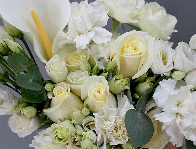 Bridal bouquet with white roses, lisianthus, dianthus, and eucalyptus photo