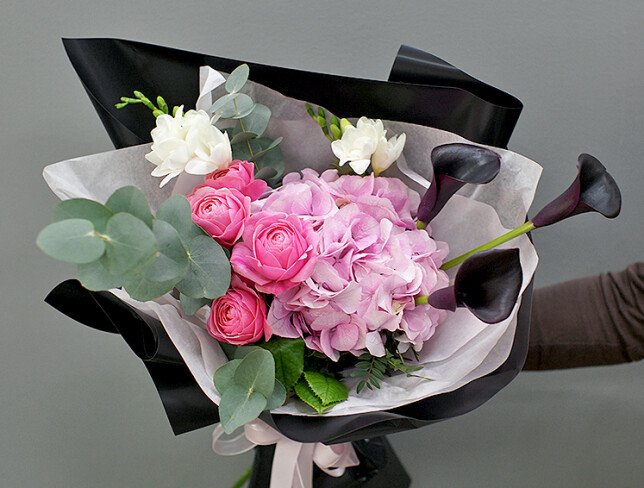 Bouquet of pink hydrangea and black calla lilies photo
