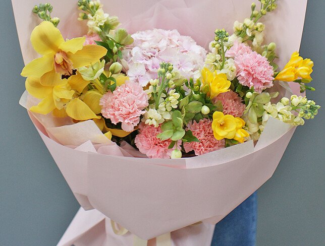 Bouquet with pink hydrangea, dianthus, and yellow orchids photo