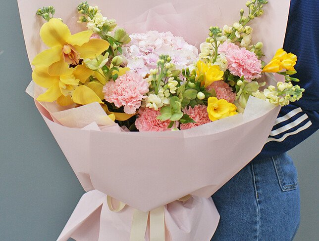 Bouquet with pink hydrangea, dianthus, and yellow orchids photo