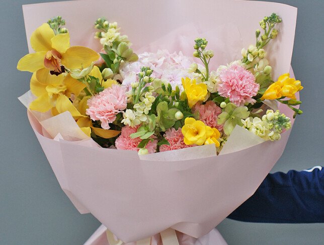 Bouquet with pink hydrangea, dianthus, and yellow orchids photo