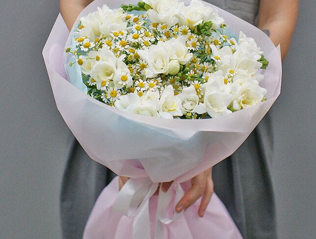 Bouquet of white freesias and wild daisies photo