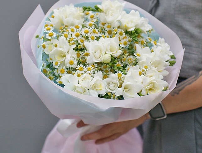 Bouquet of white freesias and wild daisies photo