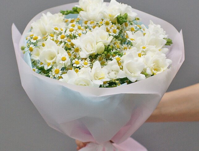 Bouquet of white freesias and wild daisies photo