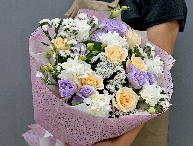 Bouquet of cream roses, white freesia, and eustoma photo
