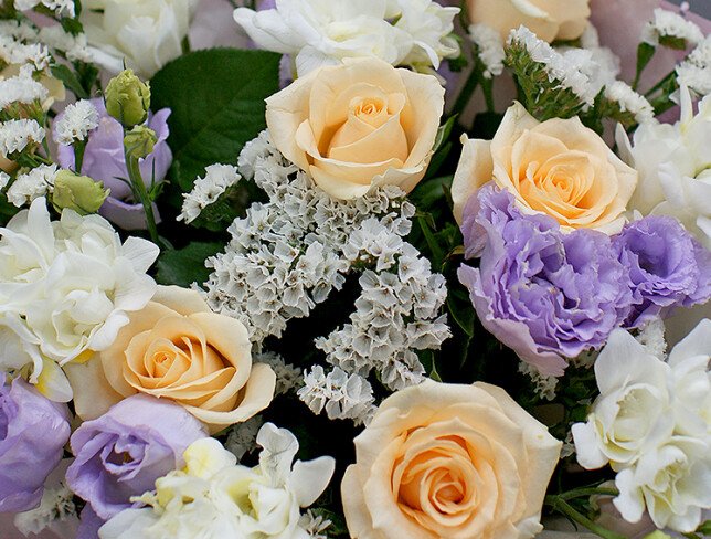 Bouquet of cream roses, white freesia, and eustoma photo