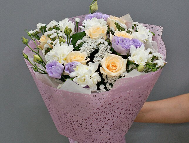 Bouquet of cream roses, white freesia, and eustoma photo