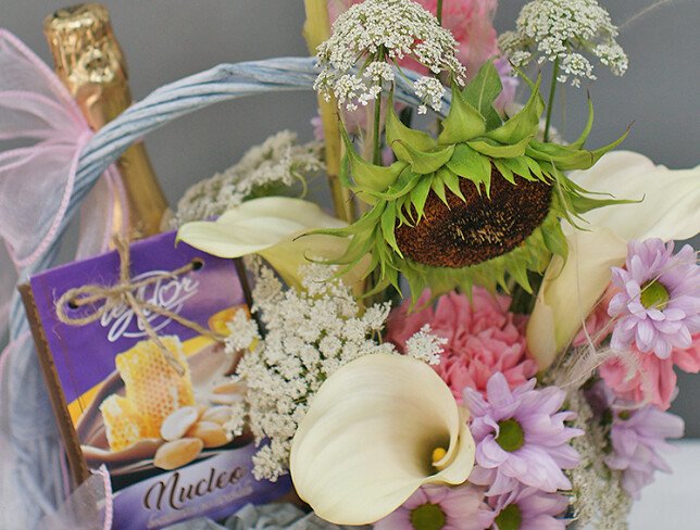 Basket with white calla lilies, sunflower, sweets and champagne "Basket with joys" photo