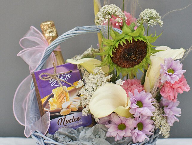 Basket with white calla lilies, sunflower, sweets and champagne "Basket with joys" photo