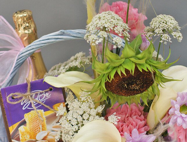 Basket with white calla lilies, sunflower, sweets and champagne "Basket with joys" photo