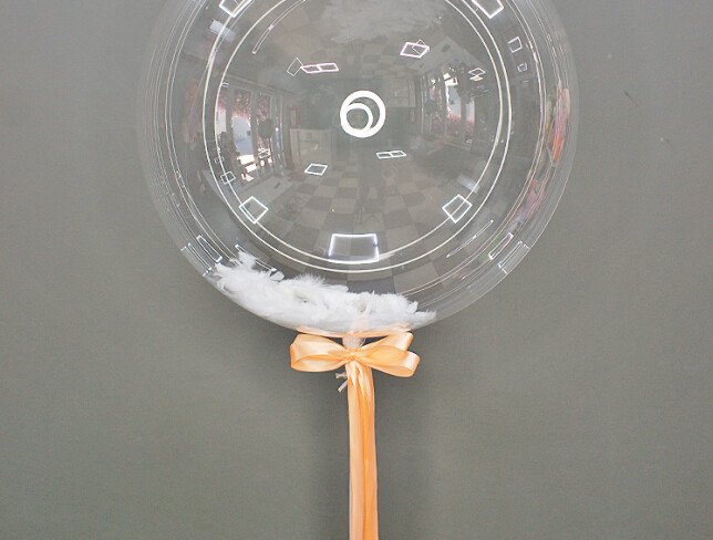 Transparent balloon with feathers photo