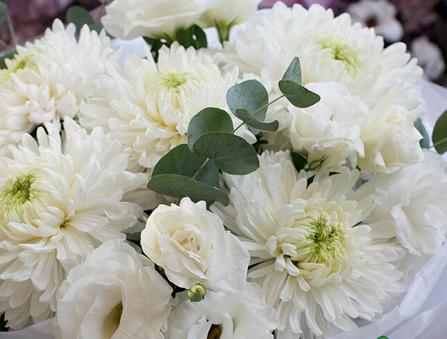 Bouquet with white spherical chrysanthemums and eustomas photo