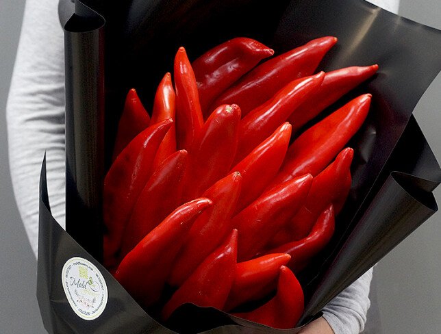 Red pepper bouquet, wrapped in black paper, tied with a red ribbon