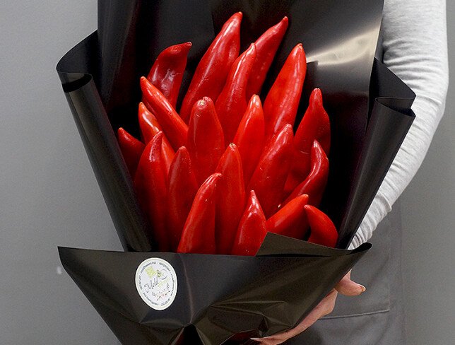 Red pepper bouquet, wrapped in black paper, tied with a red ribbon