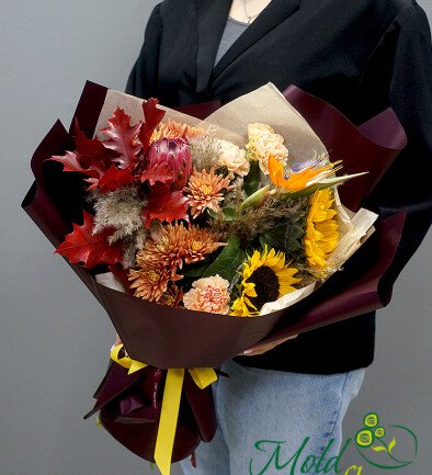 Exotic autumn bouquet with protea, sunflowers, and strelitzia