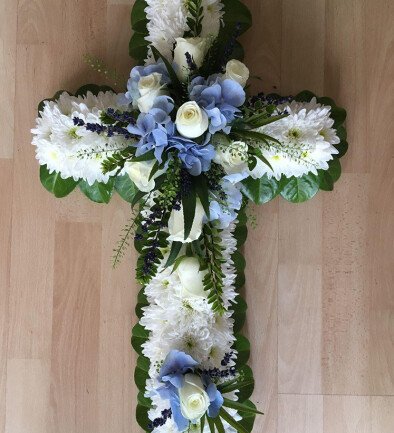 Funeral arrangement of blue hydrangea, chrysanthemums, roses, and lavender photo 394x433