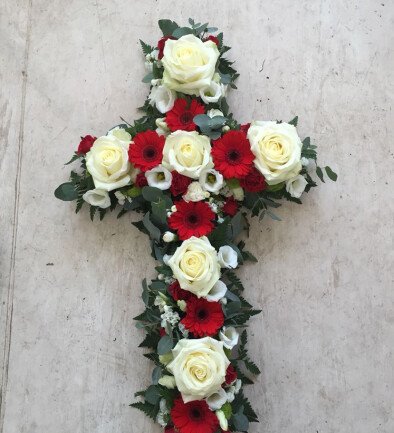 Funeral arrangement of gerberas, roses, and eustoma photo 394x433