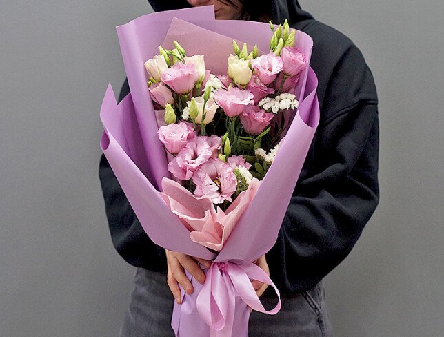 Bouquet with pink eustomas and white statice photo