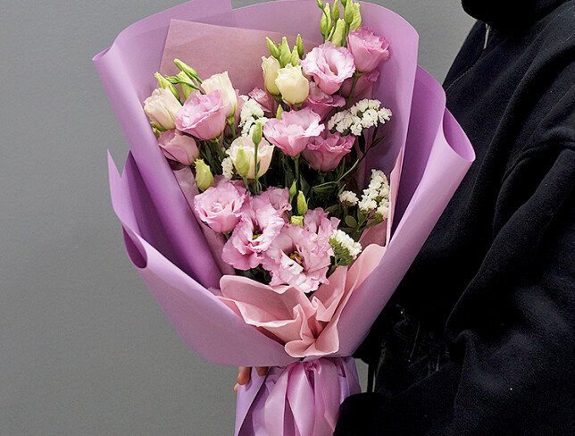 Bouquet with pink eustomas and white statice photo