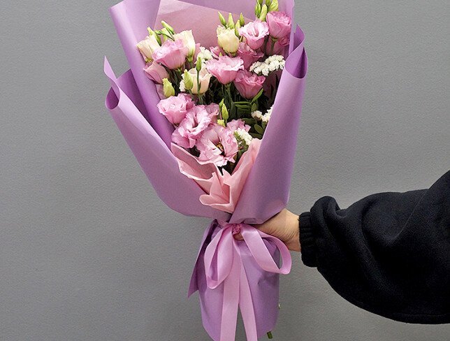 Bouquet with pink eustomas and white statice photo