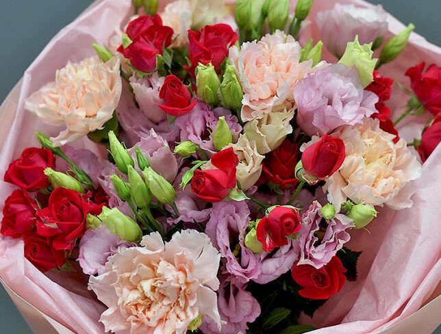 Bouquet of pink eustomas and fuchsia spray roses photo