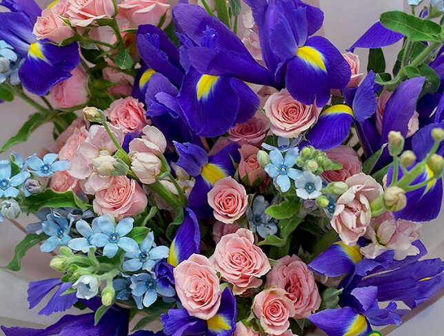 Bouquet of pink spray roses, irises and oxypetalum photo