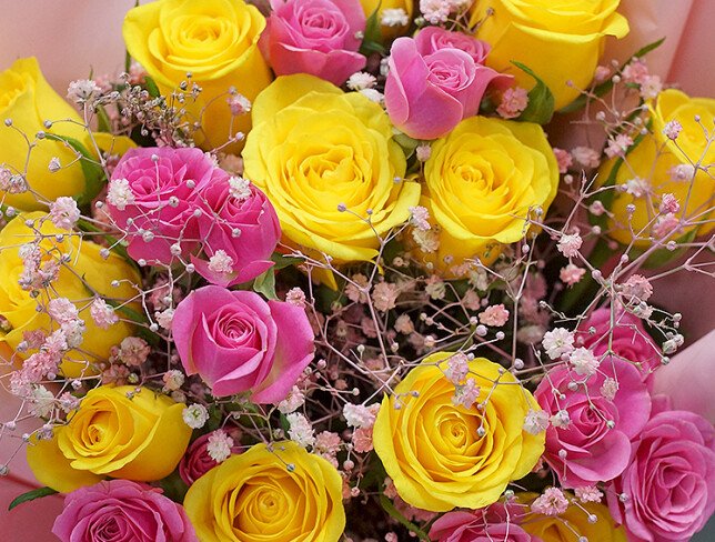 Bouquet of yellow and pink spray roses and gypsophila photo