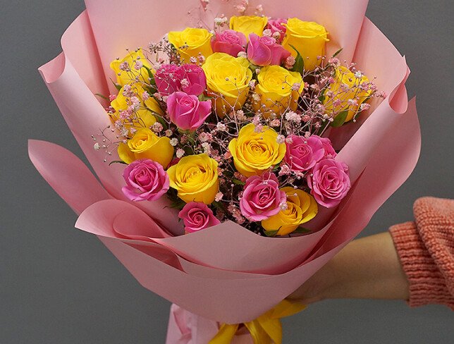 Bouquet of yellow and pink spray roses and gypsophila photo