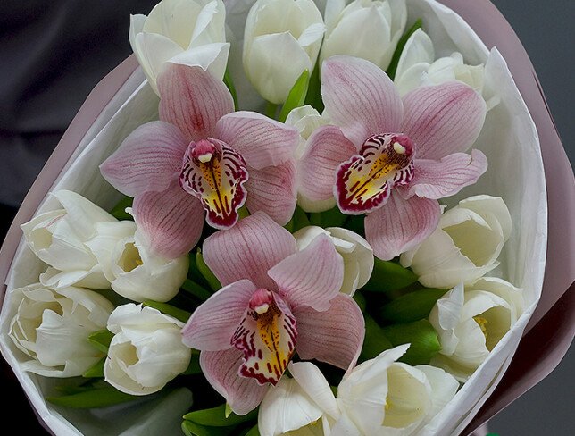 Bouquet of white tulips and pink orchids photo