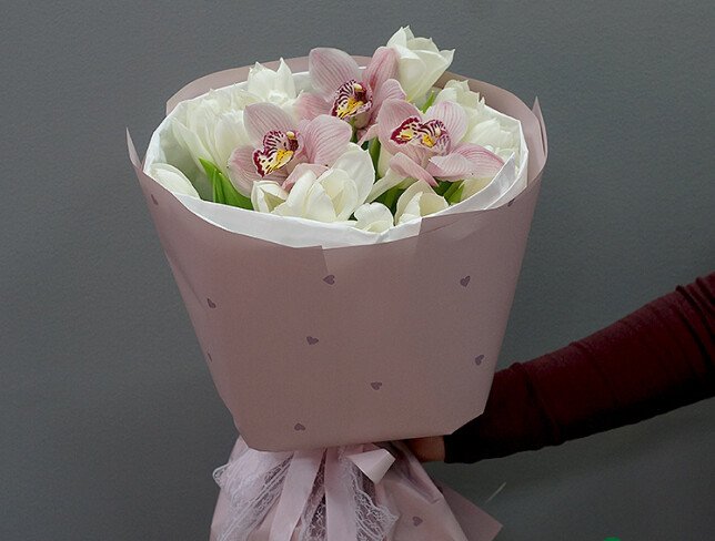 Bouquet of white tulips and pink orchids photo