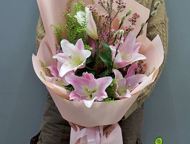 Bouquet with pink lilies, waxflower, and willow photo