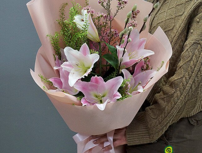 Bouquet with pink lilies, waxflower, and willow photo