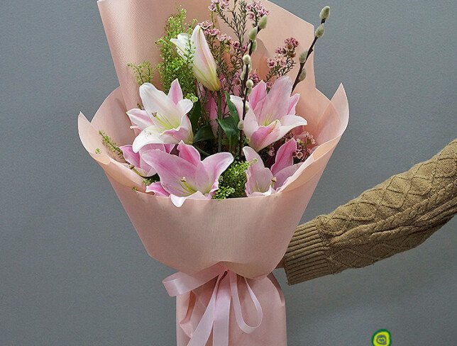 Bouquet with pink lilies, waxflower, and willow photo