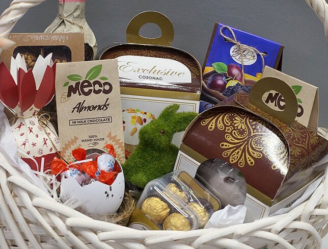 Easter basket with wine Cricova Pastoral, sweets, and panettone photo