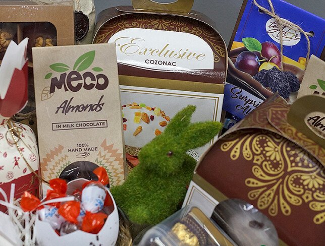 Easter basket with wine Cricova Pastoral, sweets, and panettone photo