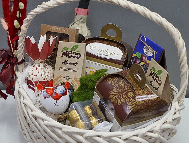 Easter basket with wine Cricova Pastoral, sweets, and panettone photo