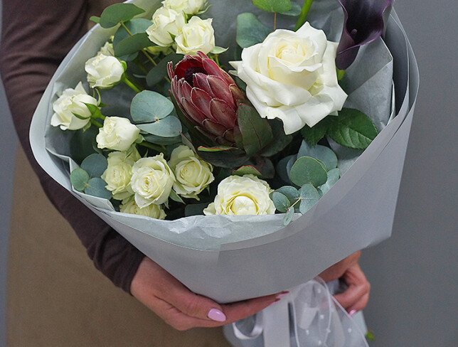 Bouquet of white spray roses, protea, and black calla lilies photo