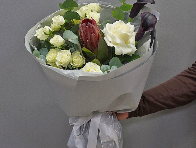 Bouquet of white spray roses, protea, and black calla lilies photo
