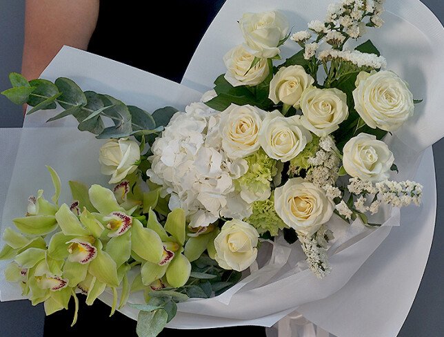 Bouquet with white hydrangea, roses, and green Cymbidium orchids photo