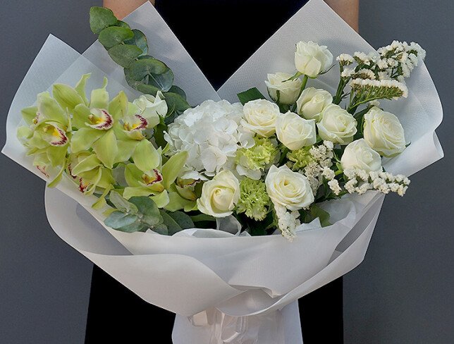 Bouquet with white hydrangea, roses, and green Cymbidium orchids photo