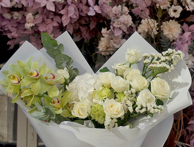 Bouquet with white hydrangea, roses, and green Cymbidium orchids photo